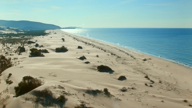 Video Reference: Coast, Body of water, Sand, Shore, Beach, Natural environment, Sea, Coastal and oceanic landforms, Ocean, Headland