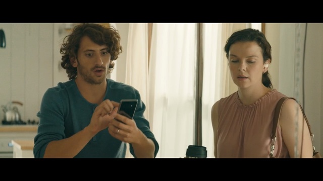 Video Reference: Conversation, Scene, Human, Fun, Adaptation, Screenshot, Person, Indoor, Woman, Man, Front, Table, Looking, Wine, Standing, Glasses, Holding, Food, Mirror, Glass, Sitting, Kitchen, Counter, Young, People, Room, Video, Shirt, Human face, Wall, Clothing, Portrait