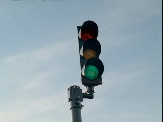 Video Reference: Traffic light, signaling device, Lighting, Light fixture, Street light, Sky, Interior design, Public utility