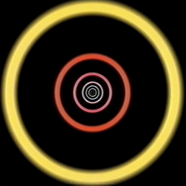 Video Reference: yellow, circle, spiral, computer wallpaper, font, spoke, graphics, wheel, rim, symbol