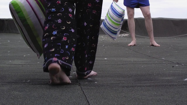 Video Reference: footwear, shoe, leg, asphalt, recreation, human leg, barefoot, foot, jeans, joint