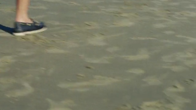 Video Reference: water, sky, floor, sand, foot, shoe, grass, outdoor shoe, vacation, flooring