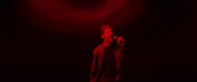 Video Reference: Red, Black, Performance, Entertainment, Darkness, Maroon, Light, Performing arts, Microphone, Music, Person