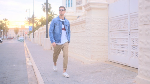 Video Reference: blue, white, photograph, denim, jeans, snapshot, outerwear, standing, fashion, shorts, Person