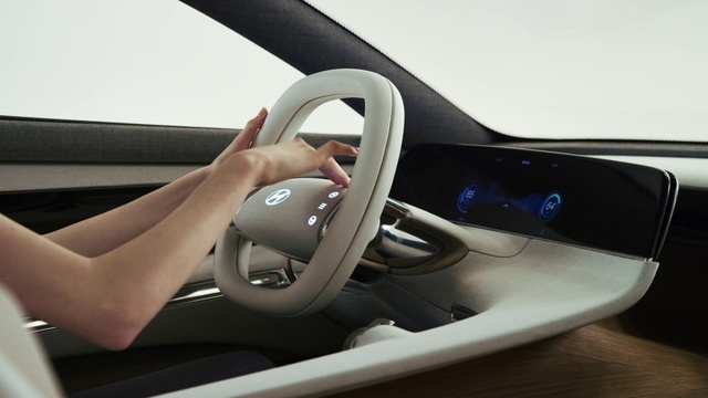 Video Reference: Vehicle, Car, Steering wheel, Steering part, Vehicle door, Automotive design, Concept car, Driving, Auto part, Personal luxury car, Indoor, Person, Woman, Sitting, Table, Desk, Computer, Young, Keyboard, Using, Video, Holding, Mouse, Girl, Laptop, Playing, Bed, Game, Remote, White, Man, Land vehicle, Car seat, Center console, Car seat cover, Mirror, Head restraint