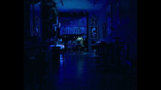 Video Reference: Blue, Light, Darkness, Purple, Electric blue, Room, Sky, Night, Architecture, Photography, Indoor, Monitor, Dark, Sitting, Table, Computer, Television, Street, Screen, View, Large, Lit, Laptop, Water, Standing, Desk, Holding, Man, Kitchen, City, Living, White, Refrigerator, Phone, Furniture, Chair