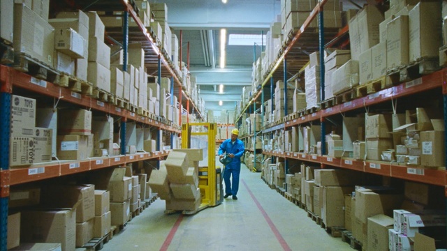 Video Reference: Aisle, Inventory, Warehouse, Building, Library, Table, Sitting, Food, Man, Room, Large, Woman, Standing, Holding, Bench, Luggage, People, White, Train, Street, Text, Shelf, Person, Book, Bookcase, Scene