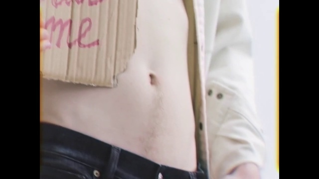 Video Reference: Abdomen, Skin, Stomach, Trunk, Chest, Outerwear, Human body, Waist, Jacket, Textile, Person, Indoor, Clothing, Man, Wearing, Sitting, Standing, Suitcase, Suit, Black, Young, Holding, Shirt, White, Table, Cake, Luggage, Woman, Cat