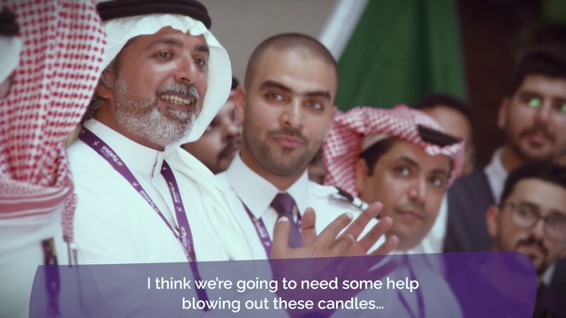 Video Reference: Moustache, Event, Photo caption, Facial hair, Smile, Headgear, Beard