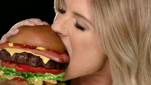 Video Reference: fast food, hamburger, junk food, food, sandwich, eating, mouth, cheeseburger, lip, veggie burger, eating