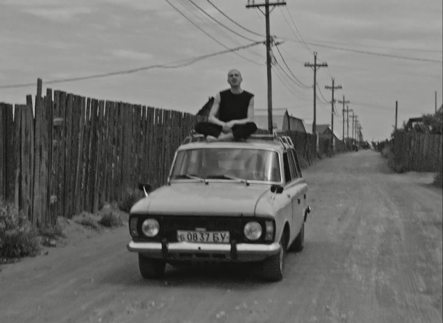 Video Reference: car, vehicle, family car, black and white, mode of transport, city car, monochrome photography, vehicle registration plate, sedan, classic car, Person