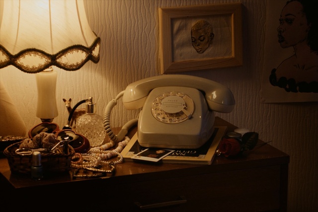 Video Reference: room, furniture, interior design, table, wood, lighting accessory, design, still life, still life photography, lampshade, Person