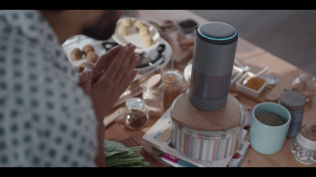 Video Reference: Auto part, Cup, Coffee, Indoor, Table, Sitting, Doughnut, Food, Donut, Chocolate, Laptop, Plate, Cake, Woman, Dog, Keyboard, Hot, Man, White, Bed, Tableware, Cluttered