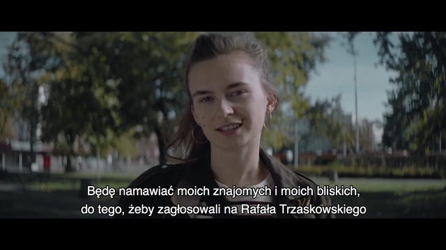 Video Reference: Photograph, Face, Facial expression, People, Photo caption, Smile, Nose, Photography, Snapshot, Happy, Person, Photo, Outdoor, Holding, Woman, Standing, Front, Smiling, Black, Young, White, Girl, Wearing, Large, Tree, Field, Man, Shirt, Game, Text, Screenshot, Human face