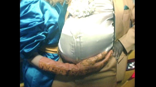 Video Reference: Arm, Abdomen, Mouth, Leg, Organism, Hand, Trunk, Tattoo, Finger, Textile, Person, Indoor, Man, Sitting, Wearing, Holding, Young, Girl, Bed, Cat, Woman, Laptop, Laying, White, Room, Standing, Shirt, Birthday cake, Text