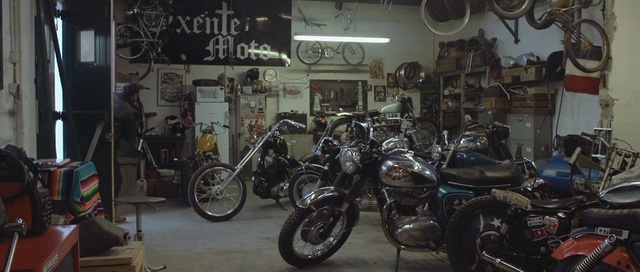 Video Reference: motorcycle, land vehicle, motor vehicle, chopper, vehicle, motorcycling, cruiser, motorcycle accessories, car, automobile repair shop