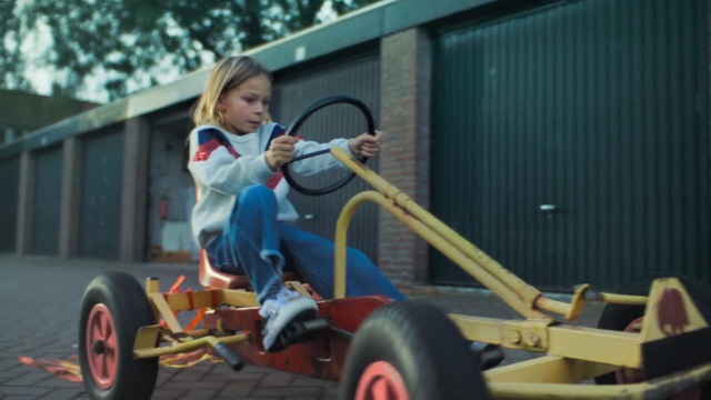 Video Reference: car, vehicle, go kart, motor vehicle, product, play, tricycle, Person