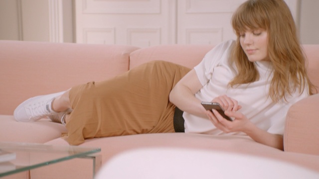 Video Reference: Comfort, Blond, Bedding, Pillow, Sitting, Leg, Furniture, Bed sheet, Linens, Long hair, Person