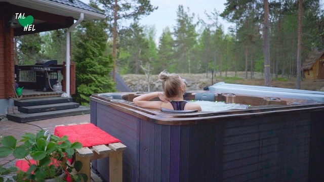 Video Reference: Jacuzzi, Leisure, Backyard, Deck, Room, Patio, Fawn, Outdoor, Table, Building, Food, House, Window, Sitting, Small, Standing, Red, Large, Wooden, Cage, Holding, Woman, Plate, White, Garden, Pizza, Kitchen, Tree, Furniture, Person, Clothing, Bench, Girl
