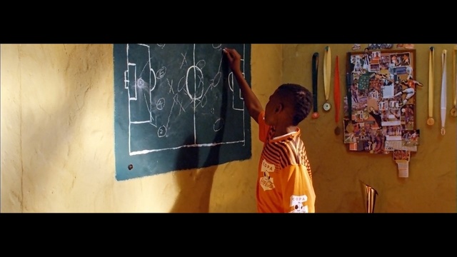 Video Reference: Blackboard, Text, Art, Snapshot, Yellow, Visual arts, Room, Adaptation, Human, Line, Person