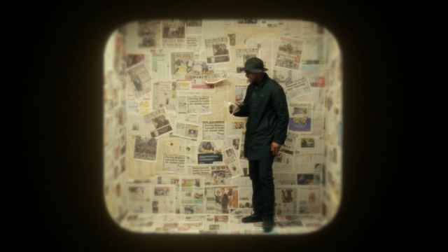Video Reference: man, black man, room, paper, newspaper, Person