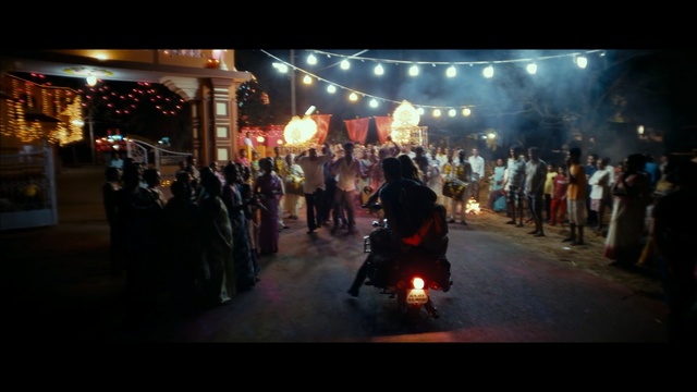 Video Reference: Crowd, Event, Tradition, Public space, Fun, Night, Temple, Evening, Performance, Performance art, Outdoor, Building, People, Dark, Street, Group, Man, Standing, City, Light, Riding, Fire, Lot, Large, Red, Dog, Room, Person, Clothing