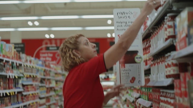 Video Reference: Supermarket, Retail, Grocery store, Convenience store, Building, Service, Person, Man, Standing, Front, Woman, Holding, Young, Food, Library, Red, Playing, Room, Table, Pizza, Text, Menu, Human face, Clothing