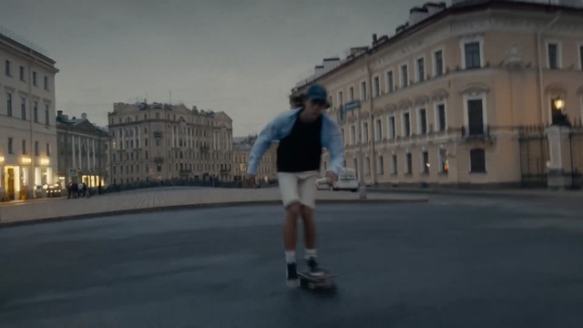 Video Reference: Photograph, Footwear, Roller skating, Skateboard, Skateboarding equipment, Snapshot, Sports equipment, Recreation, Fun, Roller skates, Road, Outdoor, Building, Street, Riding, Man, Young, Boy, City, Walking, Board, Yellow, Standing, Holding, Air, Doing, Skating, Sky, Person, Clothing, Cloud, Way