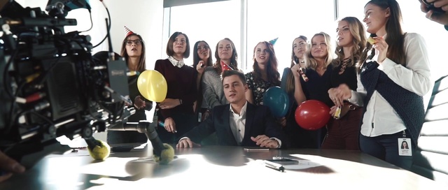 Video Reference: Smile, Table, Furniture, Tableware, Tie, Social group, Community, Desk, Balloon, Fun