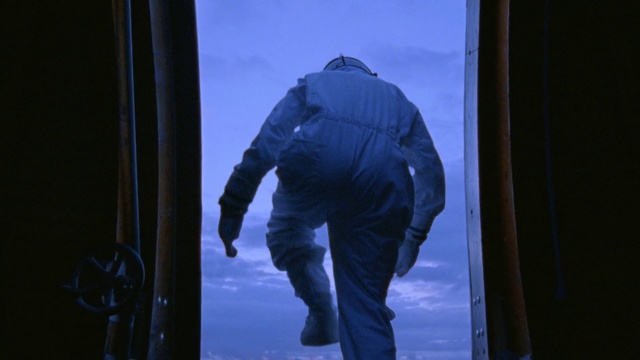 Video Reference: Blue, Snow, Standing, Winter, Outerwear, Sky, Electric blue, Ice, Jacket, Photography, Person, Outdoor, Man, Skiing, Window, Slope, Covered, Dark, Hill, Riding, Wearing, Pole, Water, Board, Holding, Clothing