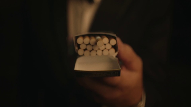 Video Reference: Still life photography, Hand, Finger, Cup, Photography, Darkness, Person, Indoor, Remote, Man, Dark, Holding, Control, Looking, Wearing, Front, Sitting, Using, Close, Shirt, Young, Lit, Computer, Black, Laptop, Screen, Someone, Red, White, Video, Standing, Game, Phone, Blurry, Fashion accessory