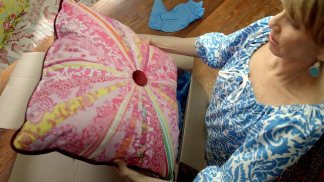 Video Reference: pink, textile, cushion, design, linens, material, pillow, pattern, flower, Person