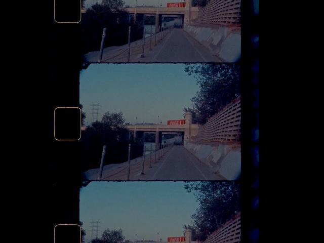 Video Reference: Sky, Cloud, Blue, Morning, Tree, Snapshot, Architecture, Line, Urban area, Window, Outdoor, Light, Traffic, Street, Sign, Dark, Red, Stop, View, City, Sitting, Intersection, Hanging, Lit, Side, Snow, Green, Driving, Signal, Standing, White, Yellow, Rain, Game, Man, Riding, People, Night, Bus, Text