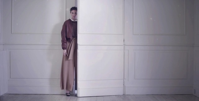 Video Reference: standing, shoulder, outerwear, fashion, floor, door, flooring, window, haute couture