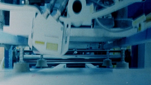 Video Reference: Machine, Indoor, Appliance, Kitchen, Sink, Table, Counter, Sitting, Small, Stove, Desk, Man, White, Room, Cooking, Large, Computer, Woman, Standing, Oven, Holding, Cluttered