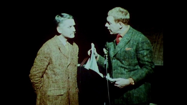 Video Reference: Photograph, Green, Head, Gentleman, Human, Male, Fun, Adaptation, Human body, Organism, Person, Man, Holding, Standing, Cake, Front, Old, Looking, Woman, Hand, Suit, Remote, Wedding, Cutting, Using, Older, Cut, White, Video, Wii, Phone, Game, Human face, Clothing, Text