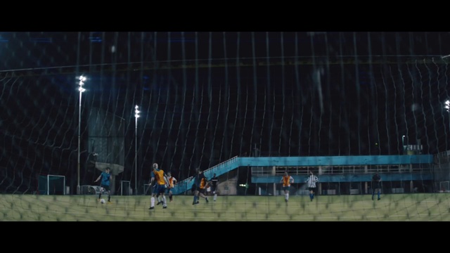 Video Reference: Stage, Light, Sport venue, Darkness, Night, Lighting, Atmosphere, Architecture, Performance, Midnight, Person, Outdoor, Bus, Sitting, Street, Water, Large, Green, Man, Standing, Walking, Red, Parked, White, People, City, Game, Sign, Group, Bridge, Blue, Boat, Riding, Playing, Soccer, Sports equipment, Screenshot