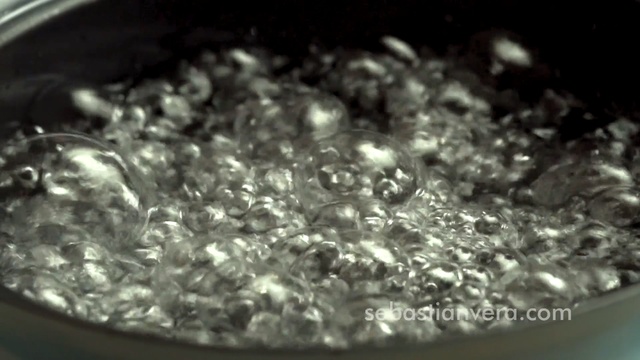 Video Reference: Water, Dish, Recipe, Boiling, Metal, Black, Sitting, Food, Pan, White, Photo, Pizza, Table, Close, Large, Cake, Holding, Plate, Dog, Board, Bowl, Laying, Glass, Droplet, Drop, Closeup, Bubble, Abstract, Plant, Tableware, Cooked