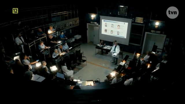 Video Reference: Stage, Crowd, Auditorium, Audience, Event, Music venue, Photography, Building, Night, Musical instrument accessory, Indoor, Room, Table, Light, Man, Standing, Large, People, Television, Lit, Street, Computer, White, Woman, Video, Sign, Traffic, Group, Kitchen, Display, Game, City, Person