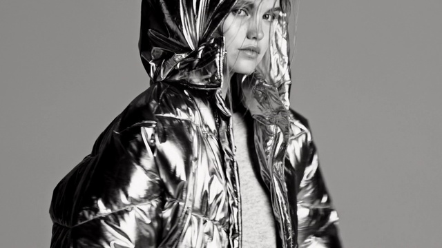 Video Reference: Clothing, Jacket, Outerwear, Fashion, Black-and-white, Leather, Photography, Monochrome, Textile, Model, Person, Man, Wearing, Holding, Black, Building, Woman, Looking, Standing, Young, Shirt, White, Phone, Human face, Fashion accessory, Black and white, Sculpture