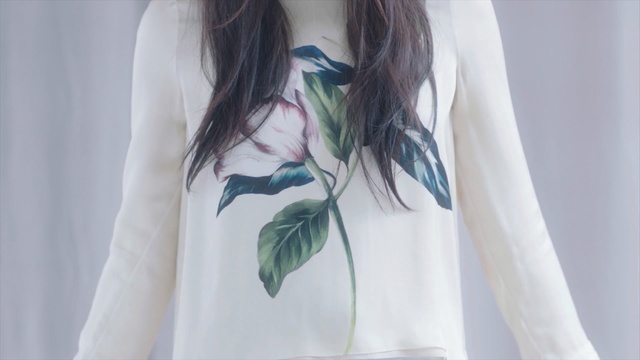 Video Reference: White, Clothing, Blue, Shoulder, Sleeve, Aqua, Turquoise, Neck, Outerwear, T-shirt