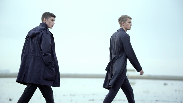 Video Reference: Clothing, Standing, Overcoat, Outerwear, Suit, Coat, Gentleman, Fashion, Human, Formal wear, Person