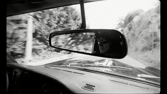 Video Reference: motor vehicle, car, black, black and white, automotive mirror, glass, monochrome photography, windshield, mode of transport, automotive design
