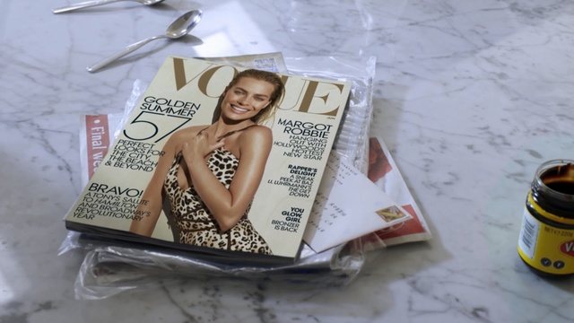 Video Reference: magazine, spoon, table, Person