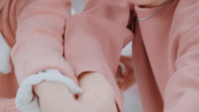 Video Reference: pink, skin, hand, finger, infant, close up, girl, nail, ear, Person