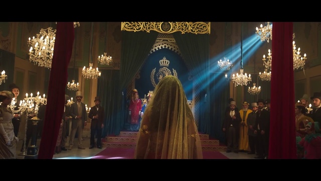 Video Reference: Photograph, Tradition, Dress, Ceremony, Event, Marriage, Temple, Photography, Place of worship, World, Building, Front, Man, Standing, Table, Light, Sign, Large, Holding, Lit, Walking, Street, Clock, Display, Crowd, People, Woman, City, Red, Room, Store, Night, White, Group, Train, Wedding dress, Text, Bride, Wedding, Clothing, Person, Altar