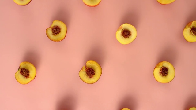 Video Reference: Yellow, Pink, Close-up, Plant, Peach, Organism, Flower, Food, Pattern, Fruit, Indoor, Counter, Colored, Table, Sitting, Hanging, Different, Bunch, Room, Banana, Kitchen, Mirror, Standing, Holding, Phone, Plate, Ball, Man, Wall, Closeup, Orange, Lemon