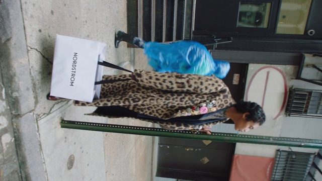 Video Reference: Organism, Felidae, Building, Table, Computer, Small, Front, Sitting, Man, Laptop, Black, Desk, Kitchen, Oven, Holding, Cat, Sink, White, Text