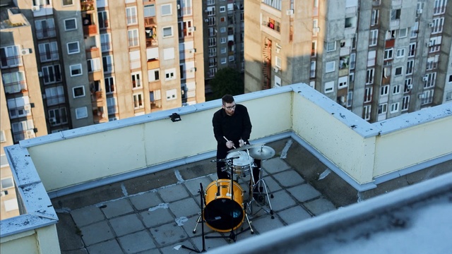 Video Reference: urban area, building, window, city, facade, roof, vehicle, street, angle, winter, Person