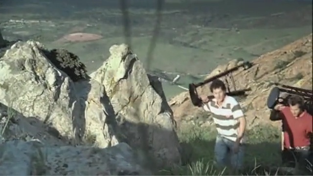 Video Reference: rock, mode of transport, geological phenomenon, wilderness, terrain, mountain, geology, mountain range, cliff, badlands, Person